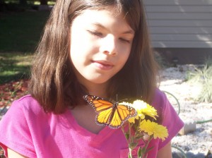 Judy's granddaughter enjoying a moment with a butterfly
