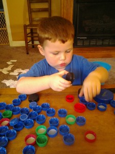 Playing a game of sorting bottle caps.