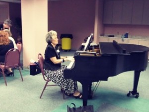 Nancy playing the piano for a program.