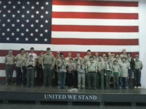 A group photo in front of the American flag on the Yorktown.