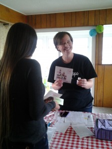 Lydia, talking to a customer about essential oils.