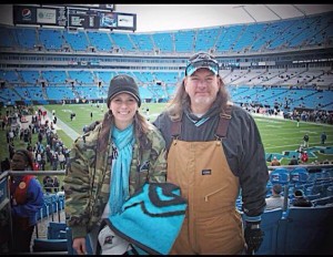 Kristin with her dad making memories at a Panther's game.