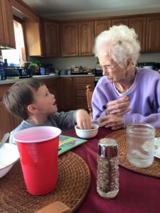 My grandson, Garrett, having a conversation with his great-grandma, my mom.