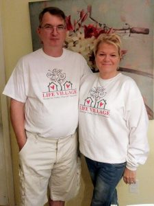 Eddie and Crystal proudly showing off their Life Village shirts.